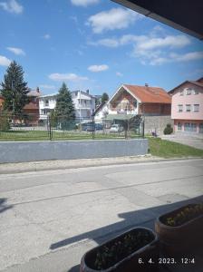 an empty street with two plants on the side of the road at Studio apartman Sokak in Bihać