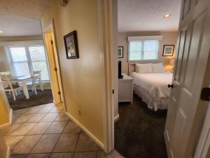 a bedroom with a bed and a dining room with a table at North Shore Inn TC 209 in Traverse City +10 photos