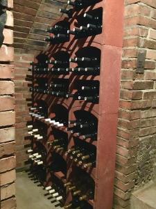 a row of wine bottles in a brick wall at Sklep u Dušana in Vracov