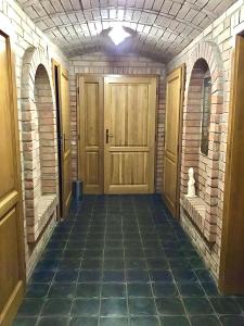 an empty hallway with a wooden door and brick walls at Sklep u Dušana in Vracov