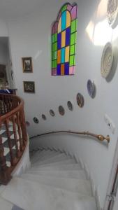 a spiral staircase with a stained glass window on the wall at Casa Las Vidrieras in Puerto Real