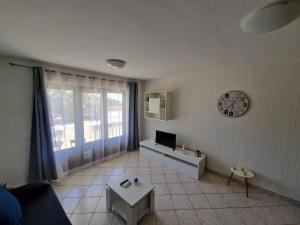 a living room with a couch and a tv at Apartman"Petra" in Krk