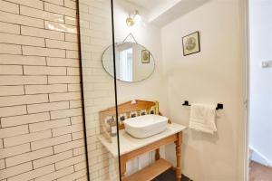 a bathroom with a sink and a shower at Nine The Boathouse in Rye