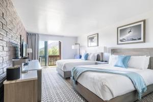 a hotel room with two beds and a television at Snow King Resort in Jackson