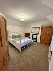 a bedroom with a bed and a television in it at Station House-Hinton Admiral in Christchurch