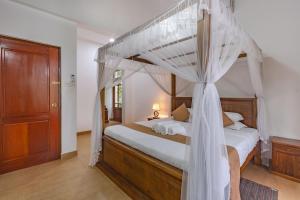 a bedroom with a bed with a canopy bed at Villa Mount Melody in Kandy