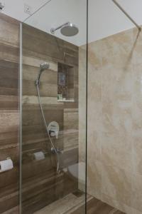 a shower with a glass door in a bathroom at Villa Mount Melody in Kandy