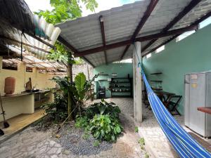a patio with a hammock in a room at Hostel Moreré in Moreré