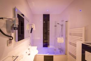 y baño con ducha, lavabo y aseo. en The Originals City, Hôtel La Saulaie, Saumur Ouest (Inter-Hotel), en Doué-la-Fontaine