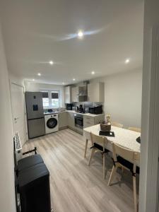 a living room with a table and a kitchen at The Rita House in Doncaster