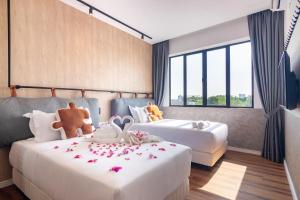 a bedroom with two beds with stuffed animals on them at Bagan Suite in Butterworth