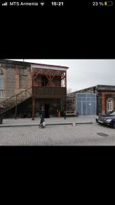 a person walking in front of a building at Old House Gyumri in Gyumri