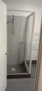 a shower with a glass door in a bathroom at Near Train Station Transport Hub with Bicycle Locker in Perth