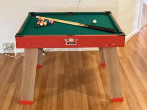 a snooker table with a pool cue on it at 12 person holiday home in Vinderup in Vinderup