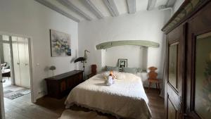 a bedroom with a bed and a table with a candle on it at Gite BI UNS chez Silvana in Colmar