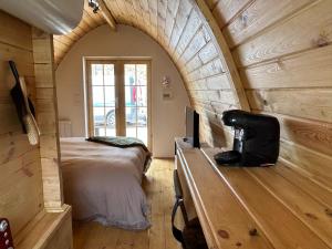 a bedroom with a bed and a desk in a room at Les Chalets du Parc in Saint-Eulien