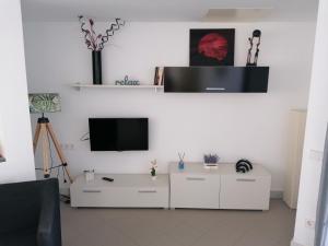 a living room with a tv and a white cabinet at Apartamento Viento Del Sur in Las Negras