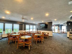 a dining room with tables and chairs and windows at Celebrity Inn in Branson