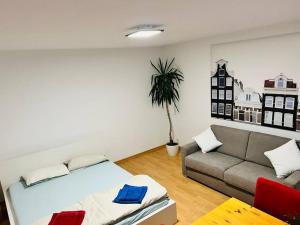 a living room with a bed and a couch at Ferienwohnung in Rheinnähe in Rheinbreitbach