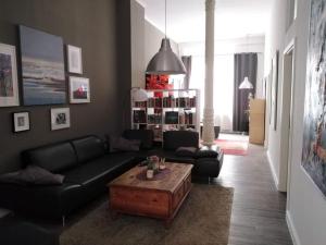 a living room with a couch and a coffee table at Loft Wernigerode Erdgeschoss in Wernigerode