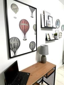 a laptop computer sitting on a desk in a room at Cómodo y acogedor apartamento in Madrid