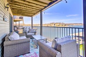 a porch with chairs and a table on a balcony at Osage Beach Resort Condo with Community Pool! in Osage Beach