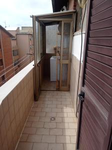 an open door to a bathroom on a balcony at Casa Medea in Piombino