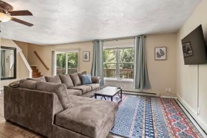 a living room with a couch and a table at Spacious Wine Country Retreat Close to Ithaca in Lansing