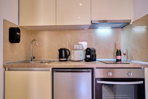 a kitchen with a sink and a counter top at Sunflower Suites Gouvia Corfu in Gouvia