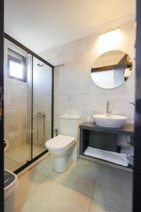 a bathroom with a toilet and a sink and a shower at AKBÜK TAŞ OTEL in Akbük