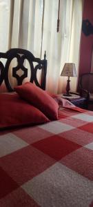 a bedroom with a bed with a red and white checkered floor at El Pedregal Sopó in Sopó