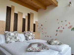 a white couch with pillows on it in a room at Agritur La Corte dei Ciliegi in Trento