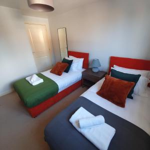 Ένα ή περισσότερα κρεβάτια σε δωμάτιο στο Ideal Coach House