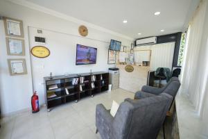a living room with two couches and a tv at AKBÜK TAŞ OTEL in Akbük
