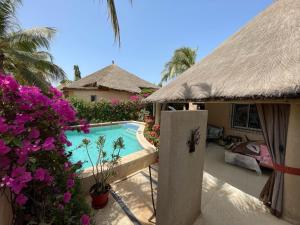 a resort with a swimming pool and a house at Agence Adjana Resort in Saly Portudal