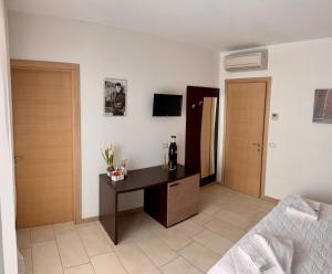 a bedroom with a desk and a bed in a room at Bed & Breakfast La Rondinella in Cerasolo +3 photos