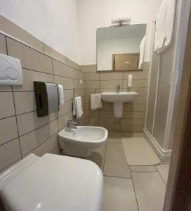 a bathroom with a toilet and a sink at Bed & Breakfast La Rondinella in Cerasolo