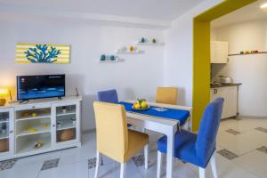 a kitchen and dining room with a table and chairs at Casa Floriana Seaview in Capri