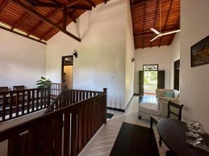 a living room with a staircase and a couch at The Bluesky Apartment in Unawatuna