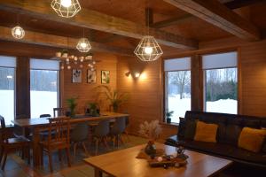 a living room with a table and a couch at Lazdkalni in Ķimale