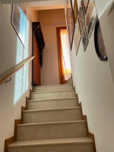 a staircase in a house with some pictures on the wall at fabio strano in Spresiano