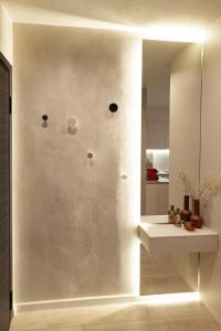 a bathroom with a mirror and a sink at Apo-Zachari elegant apartment in Larisa