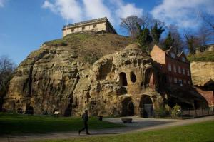a man walking in front of a large rock at STAYZED G - Edge Of Nottingham City Centre NG7, Great Amenities & Transport Links - Ideal for Short & Long Stays in Nottingham