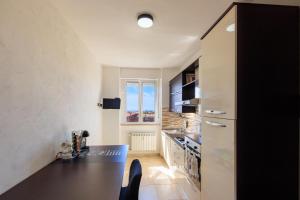 a kitchen with a black counter top in a room at L' essenziale in Livorno +51 photos