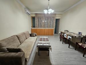 a living room with a couch and a table at Sunny Apartment close to Erebuni mall in Yerevan