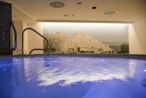 a jacuzzi tub with a view of a castle at OSTUNI PALACE - Hotel Bistrot & SPA in Ostuni