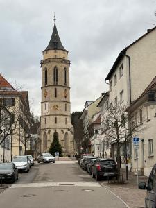 a tall building with a clock tower on a street at Zollernalbdomizil FeWo1 in Balingen
