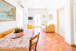 a living room with a table and a couch at Portico in Moneglia