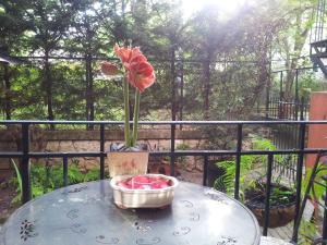 a vase with a flower on a table on a balcony at Whatever Art B&B in Lisbon