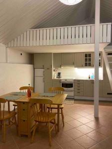 a kitchen with a table and chairs in it at Kalkugnsvägen in Kolmården